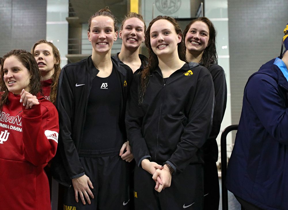 Iowa’s Hannah Burvill, Allyssa Fluit, Emilia Sansome, and Macy Rink on the podium after placing fourth in the 800 yard freestyle relay event during the 2020 Big Ten Women’s Swimming and Diving Championships at the Campus Recreation and Wellness Center in Iowa City on Wednesday, February 19, 2020. (Stephen Mally/hawkeyesports.com)