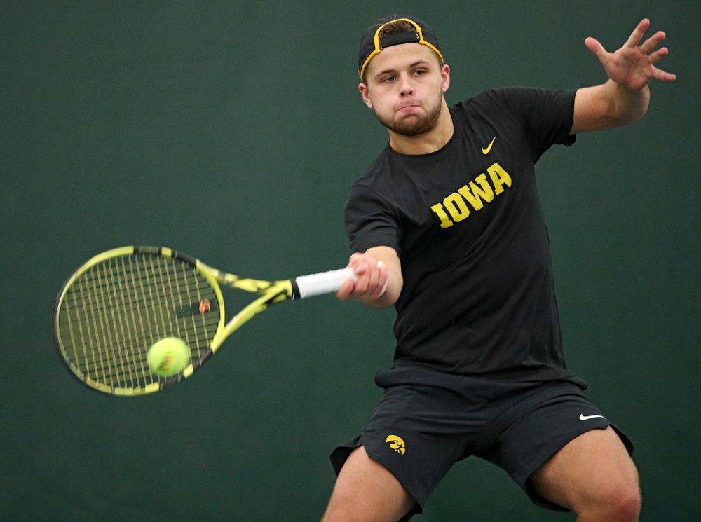 Iowa’s Will Davies hits a shot during his match against Marquette at the Hawkeye Tennis and Recreation Complex in Iowa City on Saturday, January 25, 2020. (Stephen Mally/hawkeyesports.com)