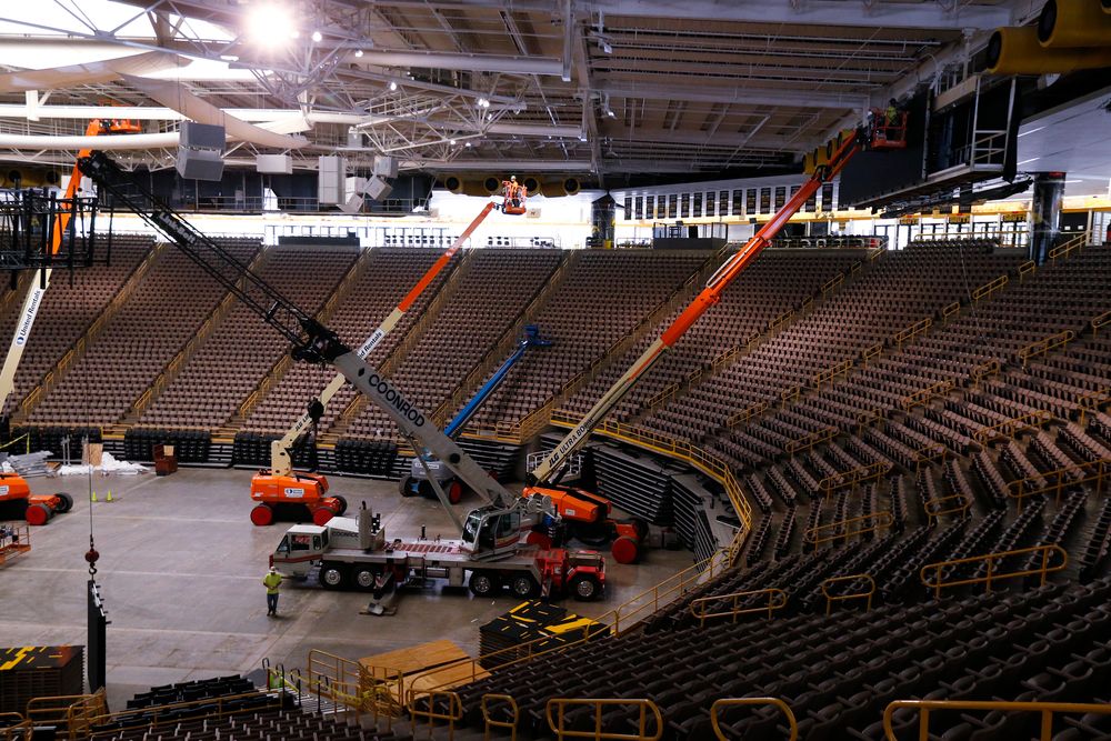 Workers install the video board at the south end of Carver.