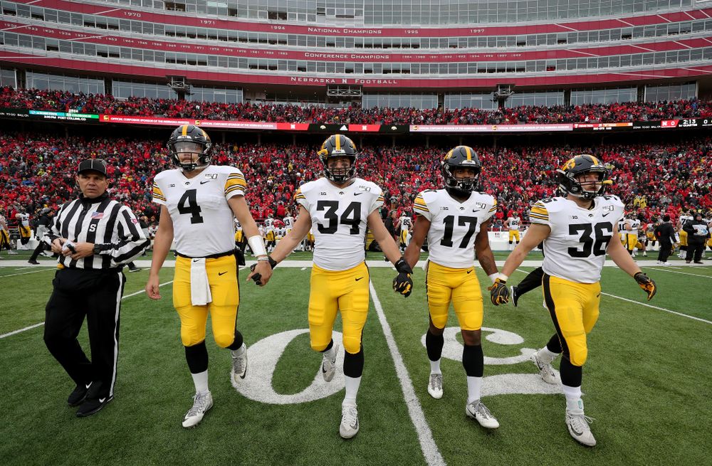 Iowa Hawkeyes captains quarterback Nate Stanley (4), linebacker Kristian Welch (34), defensive back Devonte Young (17), and fullback Brady Ross (36) against the Nebraska Cornhuskers Friday, November 29, 2019 at Memorial Stadium in Lincoln, Neb. (Brian Ray/hawkeyesports.com)