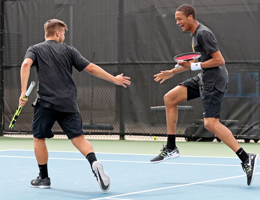Iowa's Will Davies (from left) and Oliver Okonkwo celebrate a point during a double match against Ohio State at the Hawkeye Tennis and Recreation Complex in Iowa City on Sunday, Apr. 7, 2019. (Stephen Mally/hawkeyesports.com)