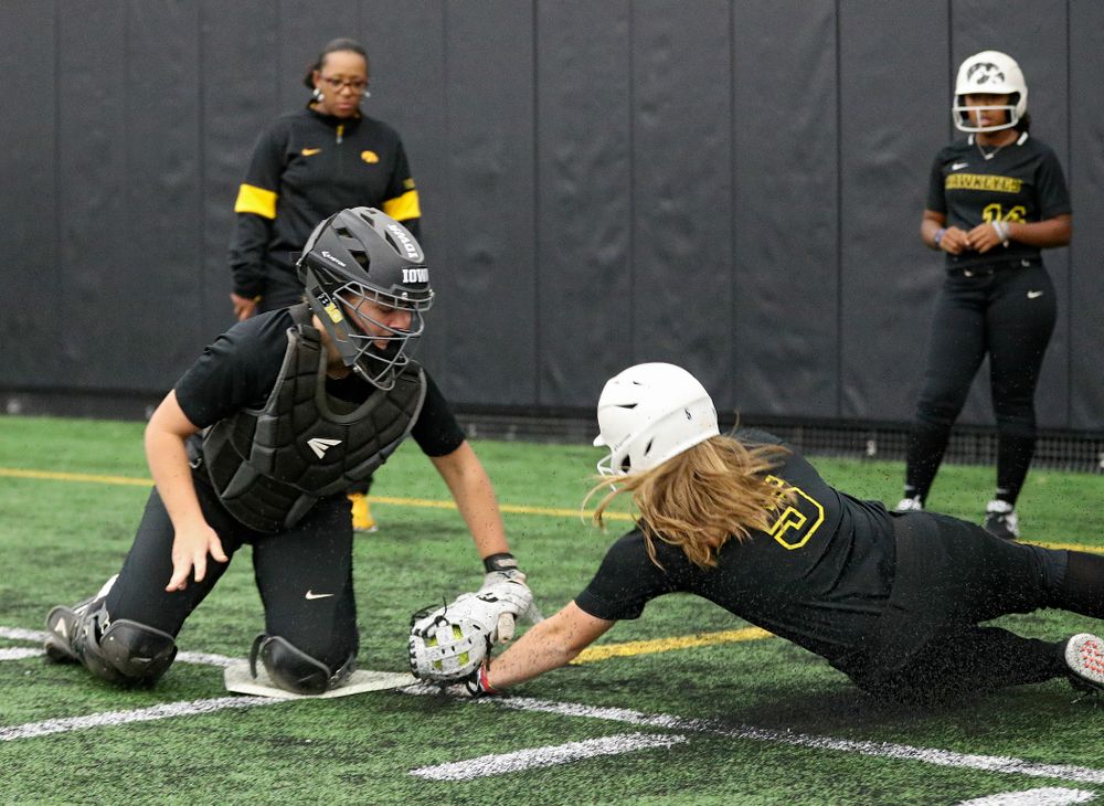 Iowa utility player/catcher Abby Lien (from left) tags infielder Sydney Owens (5) during practice at Iowa Softball Media Day at the Hawkeye Tennis and Recreation Complex in Iowa City on Thursday, January 30, 2020. (Stephen Mally/hawkeyesports.com)