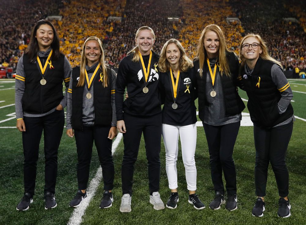 Members of the Iowa women's golf team are recognized by the Presidential Committee on Athletics at halftime during a game against Wisconsin on September 22, 2018. (Tork Mason/hawkeyesports.com)