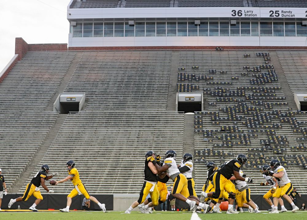 Iowa Hawkeyes quarterback Connor Kapisak (11) hands the ball off to running back Toren Young (28) during Fall Camp Practice No. 12 at Kinnick Stadium in Iowa City on Thursday, Aug 15, 2019. (Stephen Mally/hawkeyesports.com)