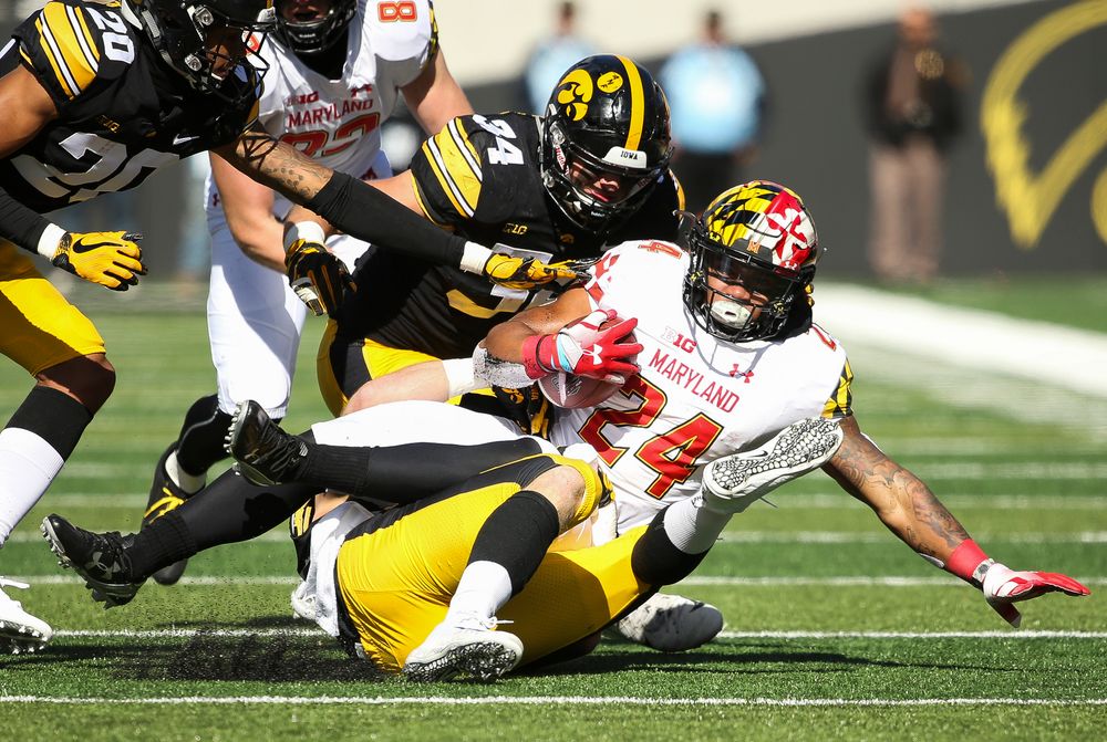 Iowa Hawkeyes defensive back Jake Gervase (30) and Iowa Hawkeyes linebacker Kristian Welch (34) make a tackle during a game against Maryland at Kinnick Stadium on October 20, 2018. (Tork Mason/hawkeyesports.com)