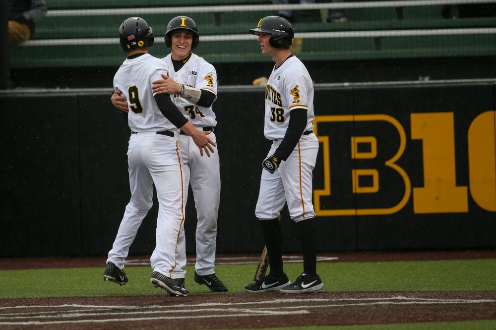 Iowa outfielder Ben Norman (9), Iowa pitcher Grant Leonard (34) Iowa pitcher Trenton Wallace (38) at game 1 vs Illinois on Friday, March 29, 2019 at Duane Banks Field. (Lily Smith/hawkeyesports.com)