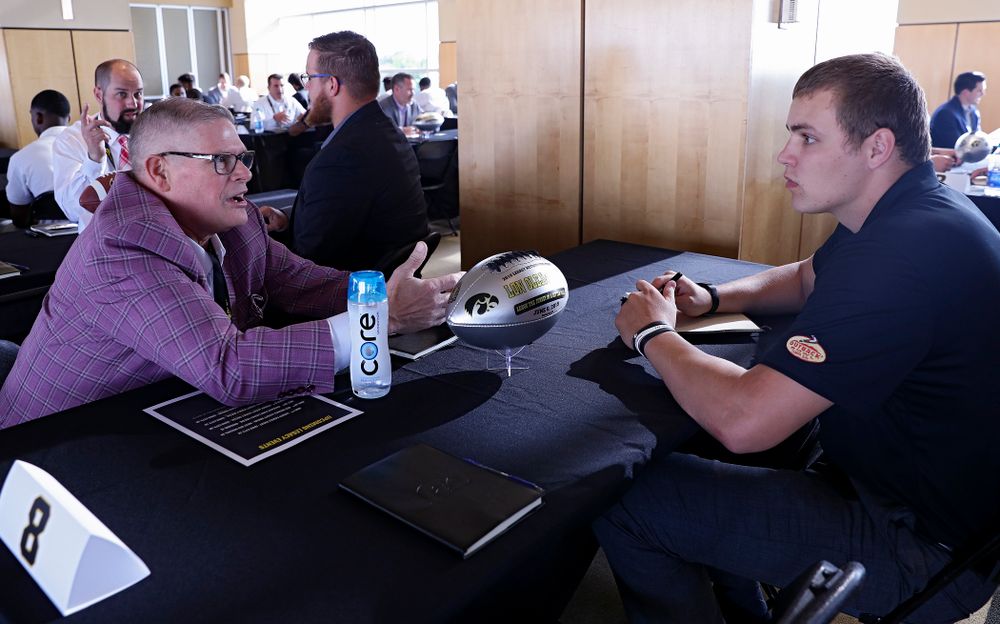 Lon Olejniczak (from left), former Iowa tight end, talks with quarterback Nate Stanley as former players meet with members of the current Hawkeye Football team during a networking event at Kinnick Stadium in Iowa City on Thursday, Jun 6, 2019. (Stephen Mally/hawkeyesports.com)