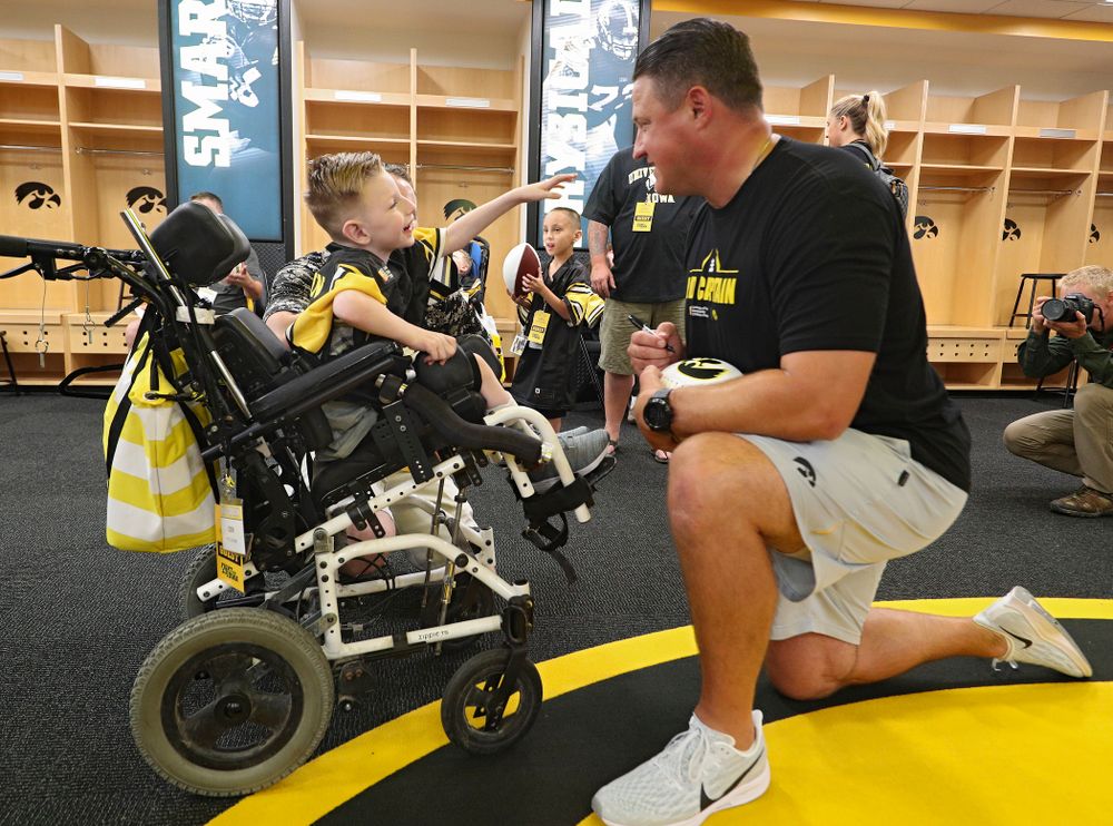 Kid Captain Cien Currie interacts with Iowa Hawkeyes offensive coordinator Brian Ferentz during Kids Day at Kinnick Stadium in Iowa City on Saturday, Aug 10, 2019. (Stephen Mally/hawkeyesports.com)