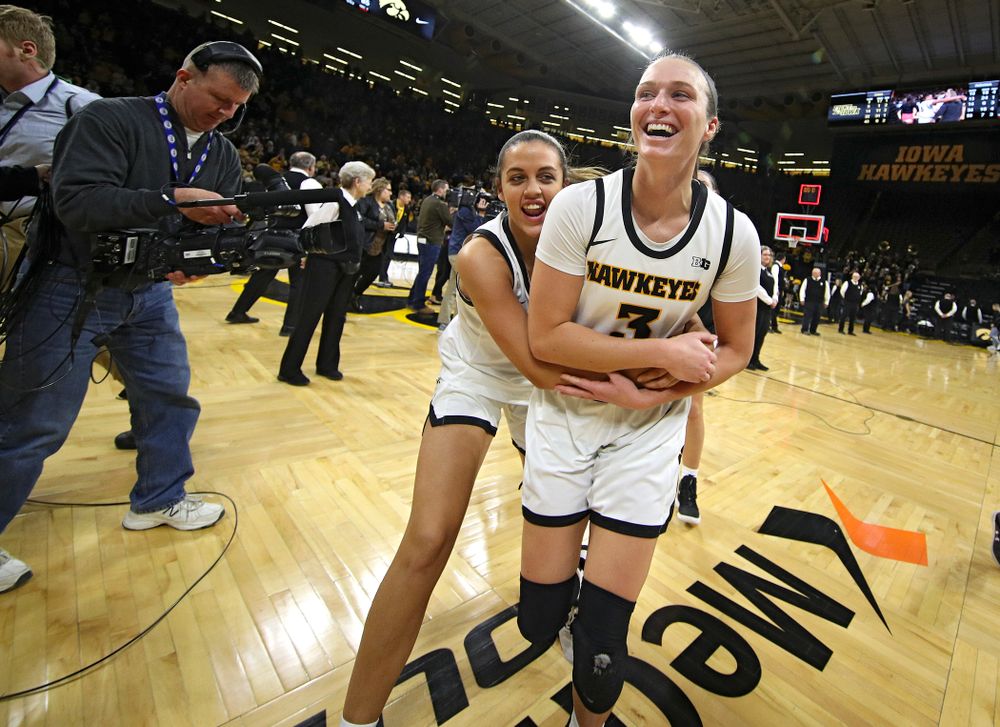 Iowa Hawkeyes guard Gabbie Marshall (24) and guard Makenzie Meyer (3) celebrate after their double overtime win at Carver-Hawkeye Arena in Iowa City on Sunday, January 12, 2020. (Stephen Mally/hawkeyesports.com)