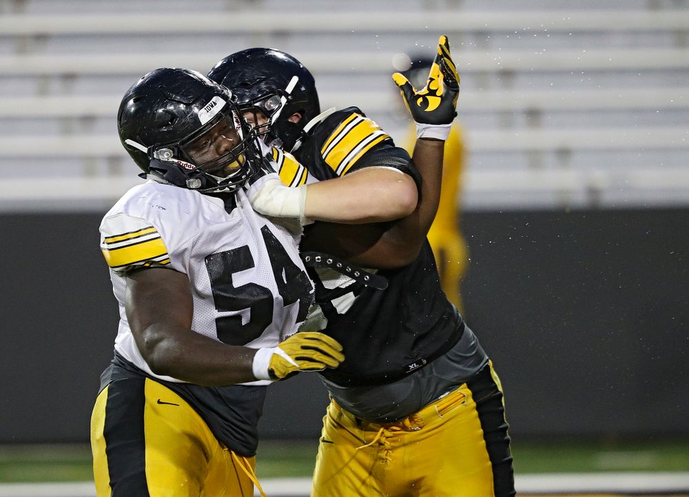 Iowa Hawkeyes defensive tackle Daviyon Nixon (54) and offensive lineman Tyler Endres (69) work on a drill during Fall Camp Practice No. 12 at Kinnick Stadium in Iowa City on Thursday, Aug 15, 2019. (Stephen Mally/hawkeyesports.com)