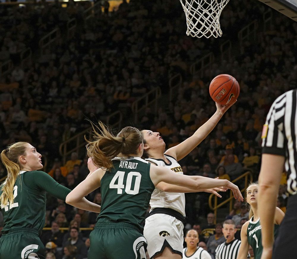 Iowa Hawkeyes guard Mckenna Warnock (14) scores a basket during the third quarter of their game at Carver-Hawkeye Arena in Iowa City on Sunday, January 26, 2020. (Stephen Mally/hawkeyesports.com)