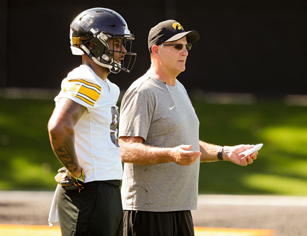 Iowa Hawkeyes defensive back Geno Stone (9) talks with defensive coordinator Phil Parker during Fall Camp Practice No. 13 at the Hansen Football Performance Center in Iowa City on Friday, Aug 16, 2019. (Stephen Mally/hawkeyesports.com)