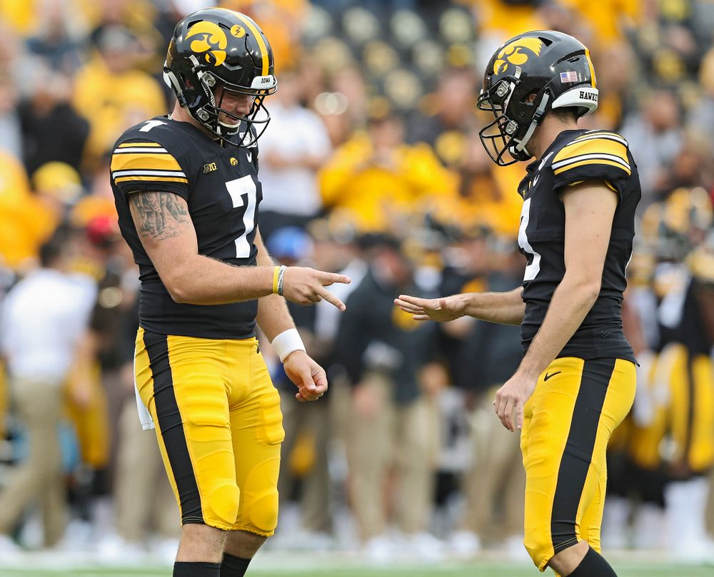 Iowa Hawkeyes punter Colten Rastetter (7) and Iowa Hawkeyes place kicker Keith Duncan (3) play rock-paper-scissors after Duncan made an extra point from the hold of Rastetter during fourth quarter of their game at Kinnick Stadium in Iowa City on Saturday, Sep 28, 2019. (Stephen Mally/hawkeyesports.com)