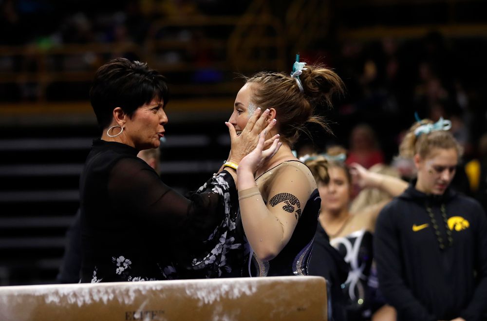 Iowa assistant coach Jennifer Green and Bre Fitzke as she competes on the beam against the Nebraska Cornhuskers 