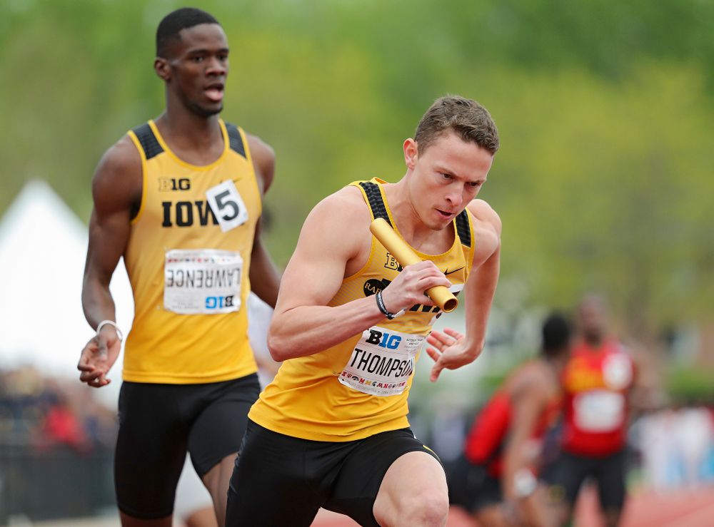 Iowa's Chris Thompson (right) takes off after receiving the baton from Wayne Lawrence Jr. during the 1600 meter relay event on the third day of the Big Ten Outdoor Track and Field Championships at Francis X. Cretzmeyer Track in Iowa City on Sunday, May. 12, 2019. (Stephen Mally/hawkeyesports.com)