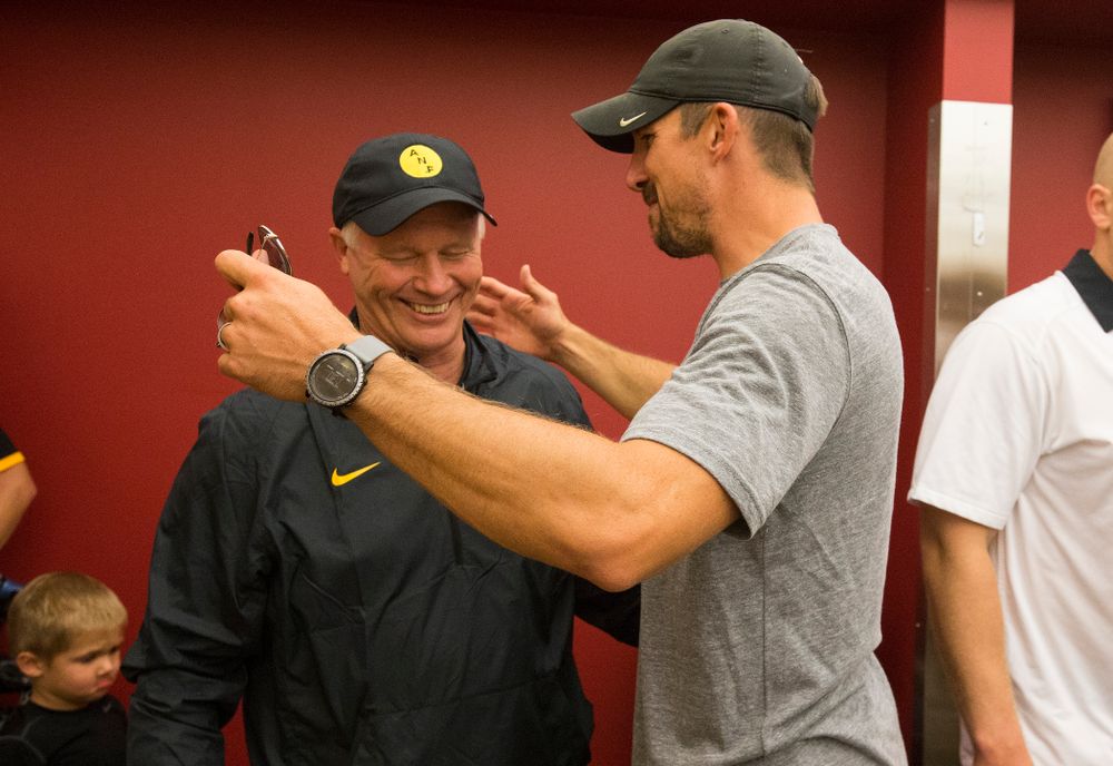 Former Iowa Hawkeyes tight end Dallas Clark talks with defensive line coach Reese Morgan as they celebrate their victory over the Iowa State Cyclones in the Iowa Corn Cy-Hawk Series Saturday, Sept. 12, 2015 at the Jack Trice Stadium in Ames.  (Brian Ray/hawkeyesports.com)