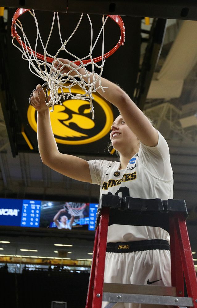 Iowa Hawkeyes guard Kathleen Doyle (22) cuts down the net after winning their second round game in the 2019 NCAA Women's Basketball Tournament at Carver Hawkeye Arena in Iowa City on Sunday, Mar. 24, 2019. (Stephen Mally for hawkeyesports.com)