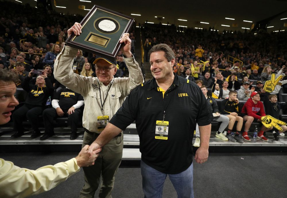 Legendary former head coach Dan Gable presents Mark Reiland with the National Wrestling Hall of Fame Lifetime Service to Wrestling Award during the Iowa Hawkeyes dual against Oklahoma State Sunday, February 23, 2020 at Carver-Hawkeye Arena. (Brian Ray/hawkeyesports.com)