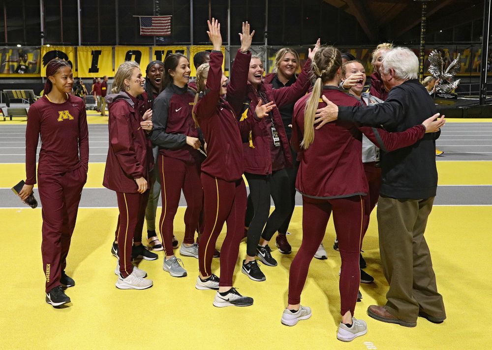 Larry Wieczorek hands out the women’s team award to Minnesota during the Larry Wieczorek Invitational at the Recreation Building in Iowa City on Saturday, January 18, 2020. (Stephen Mally/hawkeyesports.com)