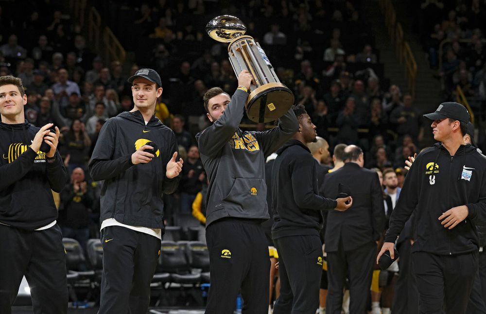 Iowa Hawkeyes punter Colten Rastetter holds up the 2019 Holiday Bowl trophy during a timeout in the first half of the game at Carver-Hawkeye Arena in Iowa City on Monday, January 27, 2020. (Stephen Mally/hawkeyesports.com)