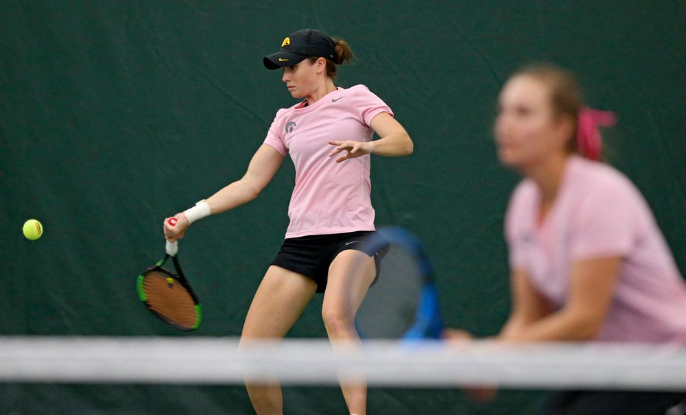 Iowa's Elise van Heuvelen Treadwell (left) lines up a shot as Ashleigh Jacobs looks on during their doubles match against Purdue at the Hawkeye Tennis and Recreation Complex in Iowa City on Friday, Mar. 29, 2019. (Stephen Mally/hawkeyesports.com)