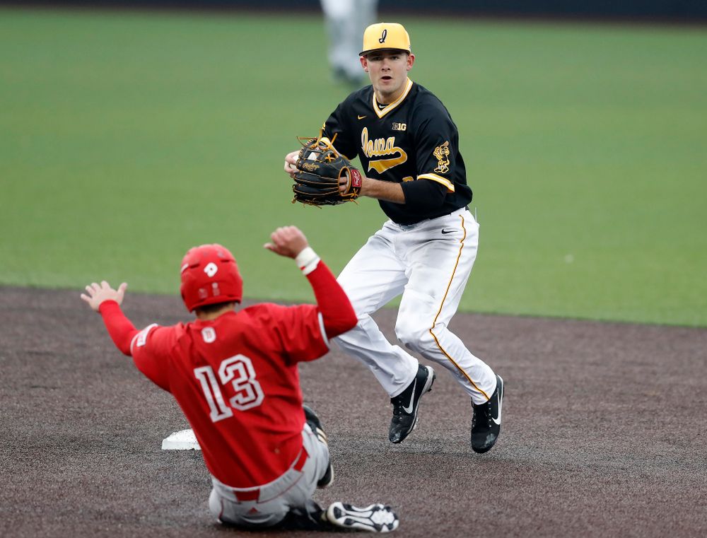 Iowa Hawkeyes infielder Kyle Crowl (23) turns a double play against the Bradley Braves Wednesday, March 28, 2018 at Duane Banks Field. (Brian Ray/hawkeyesports.com)