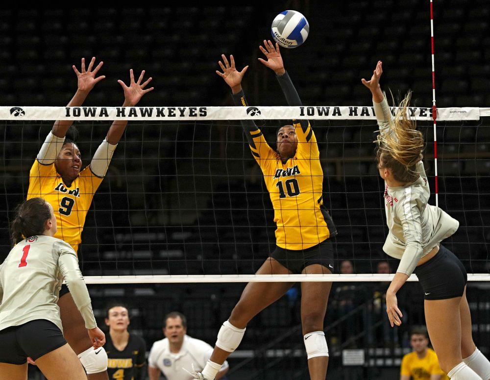 Iowa’s Griere Hughes (10) blocks a shot as Amiya Jones (9) looks on during the first set of their match at Carver-Hawkeye Arena in Iowa City on Friday, Nov 29, 2019. (Stephen Mally/hawkeyesports.com)
