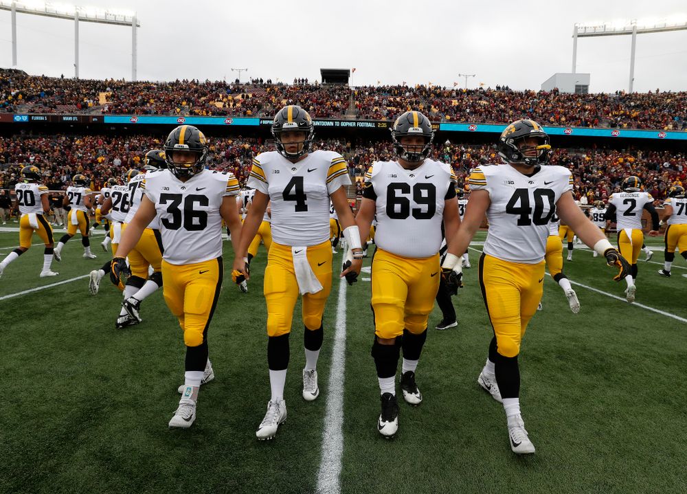 Iowa Hawkeyes captains fullback Brady Ross (36), quarterback Nate Stanley (4), offensive lineman Keegan Render (69), and defensive end Parker Hesse (40) against the Minnesota Golden Gophers Saturday, October 6, 2018 at TCF Bank Stadium. (Brian Ray/hawkeyesports.com)