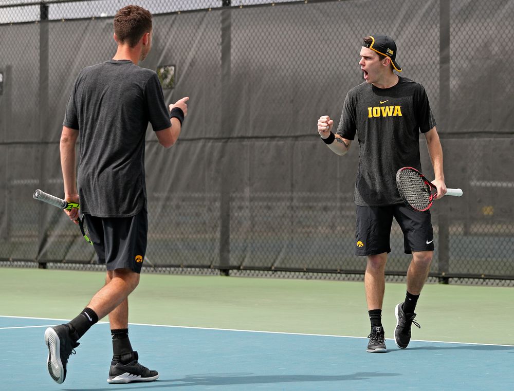 Iowa's Kareem Allaf (from left) points at Jonas Larsen as they celebrate a score during a double match against Ohio State at the Hawkeye Tennis and Recreation Complex in Iowa City on Sunday, Apr. 7, 2019. (Stephen Mally/hawkeyesports.com)