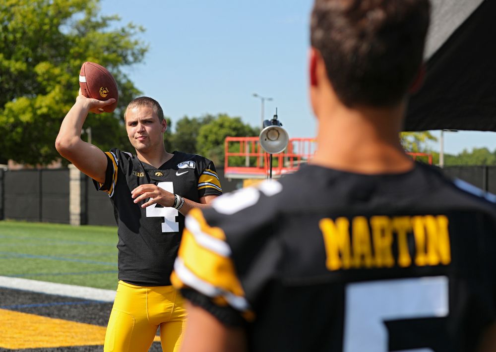 Iowa Hawkeyes quarterback Nate Stanley (4) throws a ball to wide receiver Oliver Martin (5) during Iowa Football Media Day at the Hansen Football Performance Center in Iowa City on Friday, Aug 9, 2019. (Stephen Mally/hawkeyesports.com)