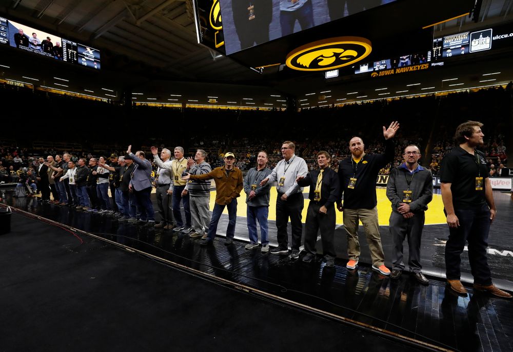 Former Big Ten champions are recognized during the Hawkeyes meet against Minnesota 