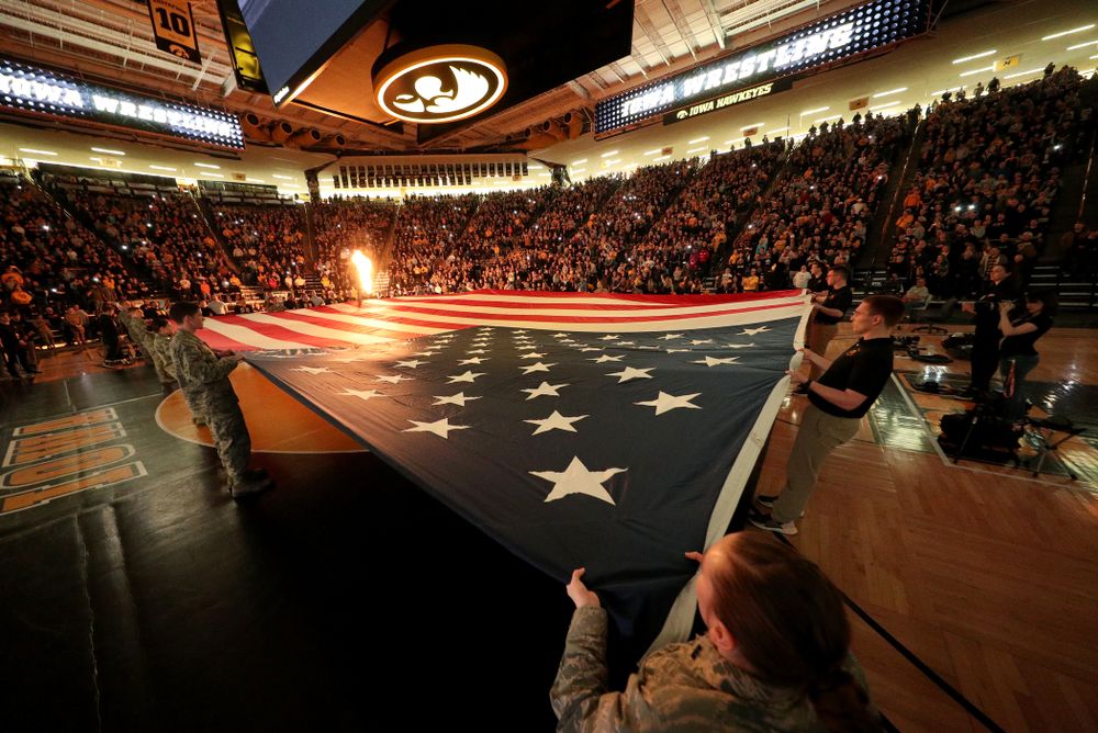 Members of the military spread out a large flag during the National Anthem before the Iowa Hawkeyes meet against Minnesota Saturday, February 15, 2020 at Carver-Hawkeye Arena. (Brian Ray/hawkeyesports.com)