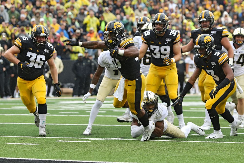 Iowa Hawkeyes running back Mekhi Sargent (10) pulls away from a defender on a touchdown run during the fourth quarter of their game at Kinnick Stadium in Iowa City on Saturday, Oct 19, 2019. (Stephen Mally/hawkeyesports.com)