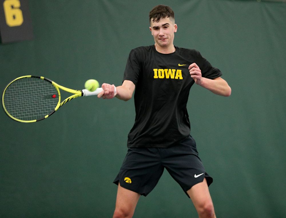 Iowa’s Matt Clegg returns a shot during their match at the Hawkeye Tennis and Recreation Complex in Iowa City on Thursday, January 16, 2020. (Stephen Mally/hawkeyesports.com)