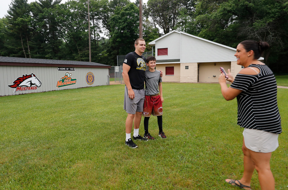 Iowa Hawkeyes quarterback Nathan Stanley (4) takes a photo with a young fan outside of his high school baseball field Wednesday, May 30, 2018 in Menomonie, Wisc. (Brian Ray/hawkeyesports.com)