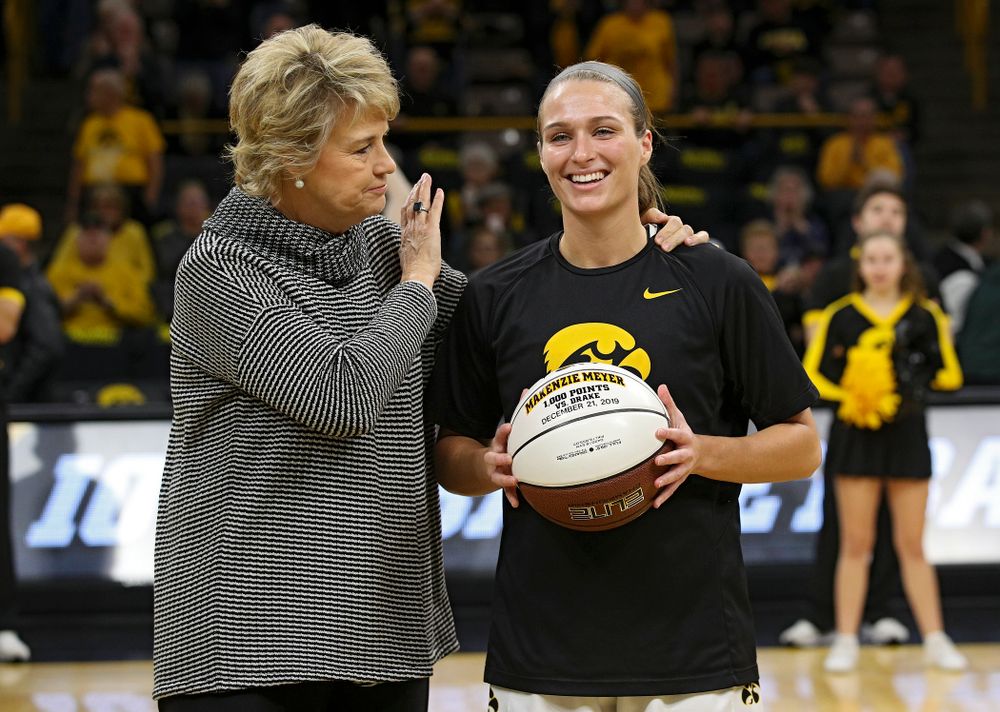 Iowa Hawkeyes head coach Lisa Bluder presents guard Makenzie Meyer (3) with a ball to honor her for scoring 1,000 career points before their game at Carver-Hawkeye Arena in Iowa City on Tuesday, December 31, 2019. (Stephen Mally/hawkeyesports.com)