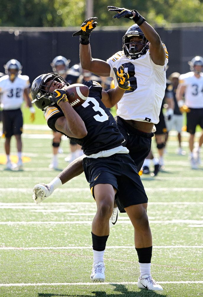 Iowa Hawkeyes wide receiver Tyrone Tracy Jr. (3) gathers in a pass around defensive back Matt Hankins (8) during Fall Camp Practice No. 13 at the Hansen Football Performance Center in Iowa City on Friday, Aug 16, 2019. (Stephen Mally/hawkeyesports.com)