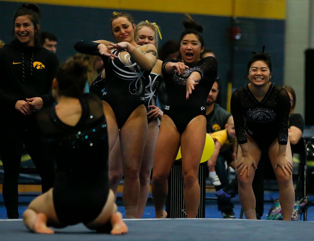 Iowa gymnasts react during Melissa Zurawski's floor routine during the Black and Gold Intrasquad meet at the Field House on 12/2/17. (Tork Mason/hawkeyesports.com)