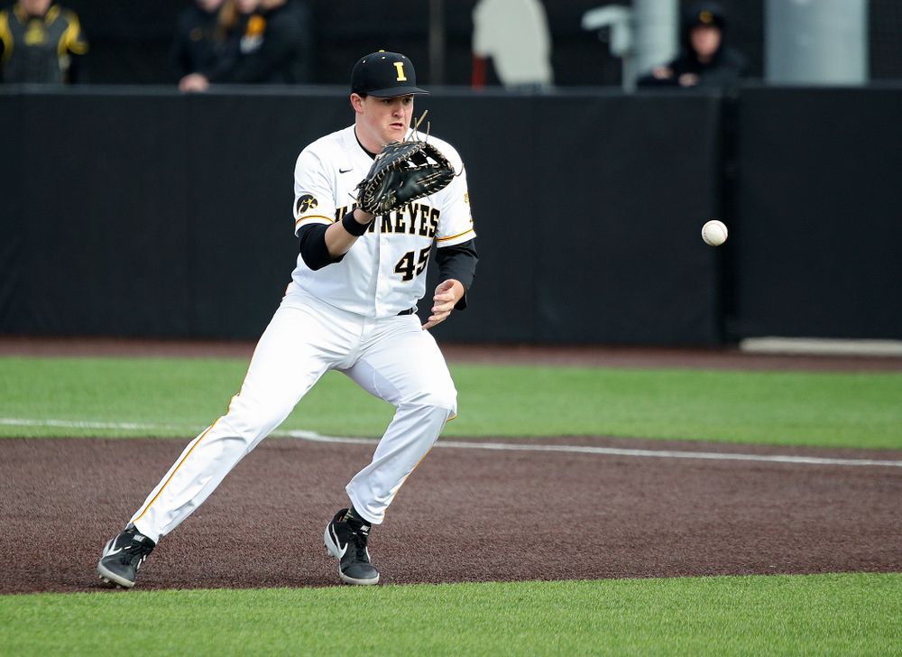 Iowa first baseman Peyton Williams (45) fields a ball before tossing it to first for an out during the seventh inning of their college baseball game at Duane Banks Field in Iowa City on Wednesday, March 11, 2020. (Stephen Mally/hawkeyesports.com)