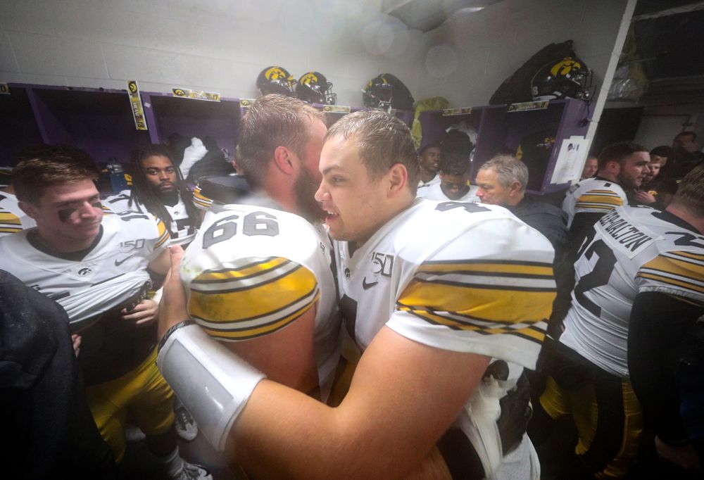 Iowa Hawkeyes offensive lineman Levi Paulsen (66) hugs quarterback Nate Stanley (4) following their victory against the Northwestern Wildcats Saturday, October 26, 2019 at Ryan Field in Evanston, Ill. (Brian Ray/hawkeyesports.com)