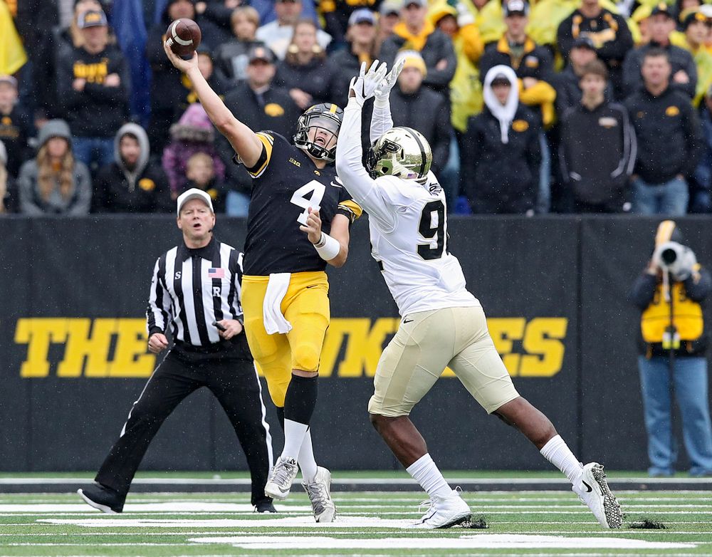 Iowa Hawkeyes quarterback Nate Stanley (4) completes a pass on the run during the third quarter of their game at Kinnick Stadium in Iowa City on Saturday, Oct 19, 2019. (Stephen Mally/hawkeyesports.com)