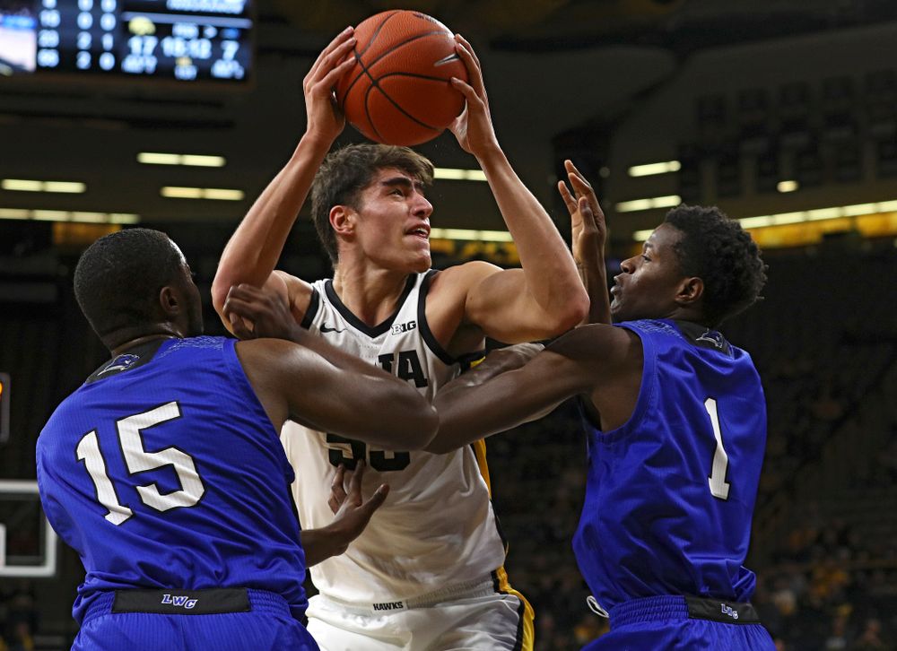 Iowa Hawkeyes center Luka Garza (55) fights through a double team to make a basket during the first half of their exhibition game against Lindsey Wilson College at Carver-Hawkeye Arena in Iowa City on Monday, Nov 4, 2019. (Stephen Mally/hawkeyesports.com)