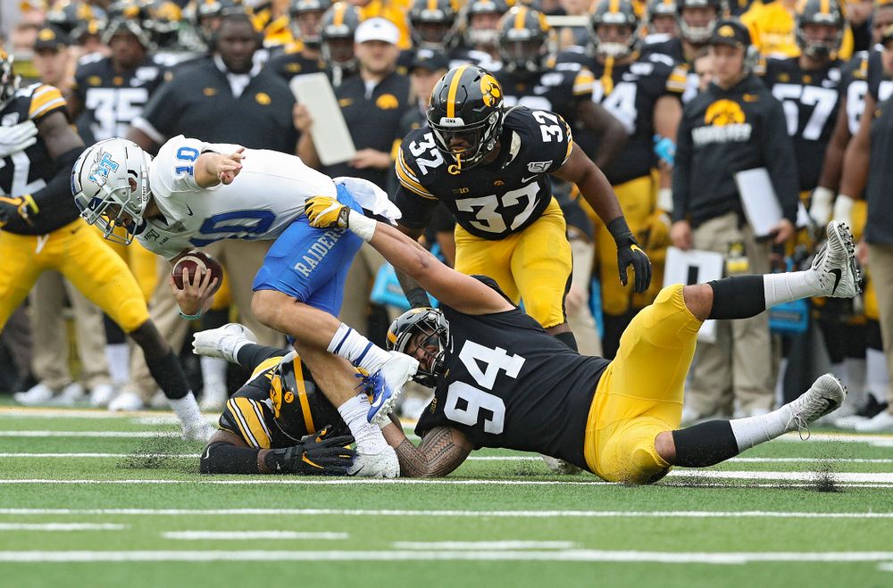 Iowa Hawkeyes defensive end Chauncey Golston (57) and defensive end A.J. Epenesa (94) tries to pull down Middle Tennessee State quarterback Asher O’Hara (10) during the second quarter of their game at Kinnick Stadium in Iowa City on Saturday, Sep 28, 2019. (Stephen Mally/hawkeyesports.com)