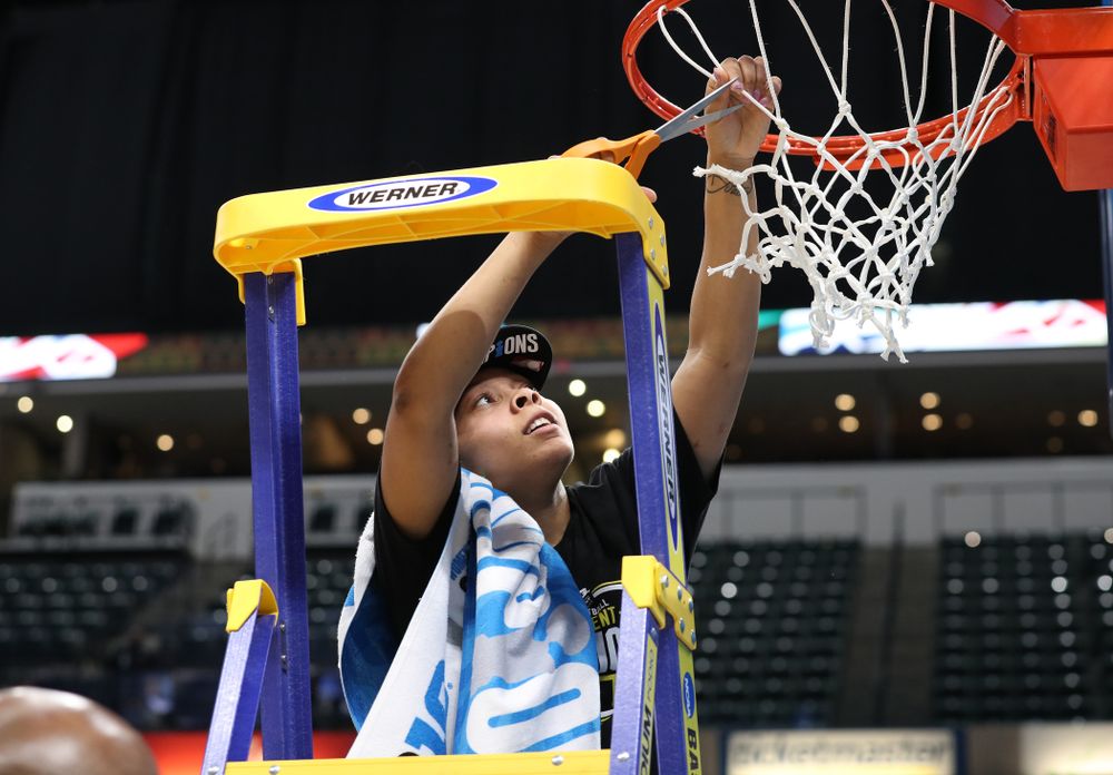 Iowa Hawkeyes guard Tania Davis (11) cuts down the net as they celebrate their victory over the Maryland Terrapins in the Big Ten Championship Game Sunday, March 10, 2019 at Bankers Life Fieldhouse in Indianapolis, Ind. (Brian Ray/hawkeyesports.com)