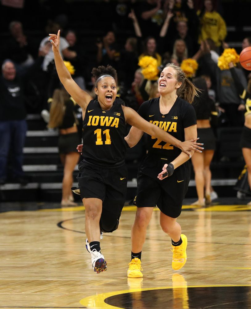 Iowa Hawkeyes guard Tania Davis (11) and guard Kathleen Doyle (22) celebrate their 73-70 win against the Iowa State Cyclones in the Iowa Corn Cy-Hawk Series Wednesday, December 5, 2018 at Carver-Hawkeye Arena. (Brian Ray/hawkeyesports.com)