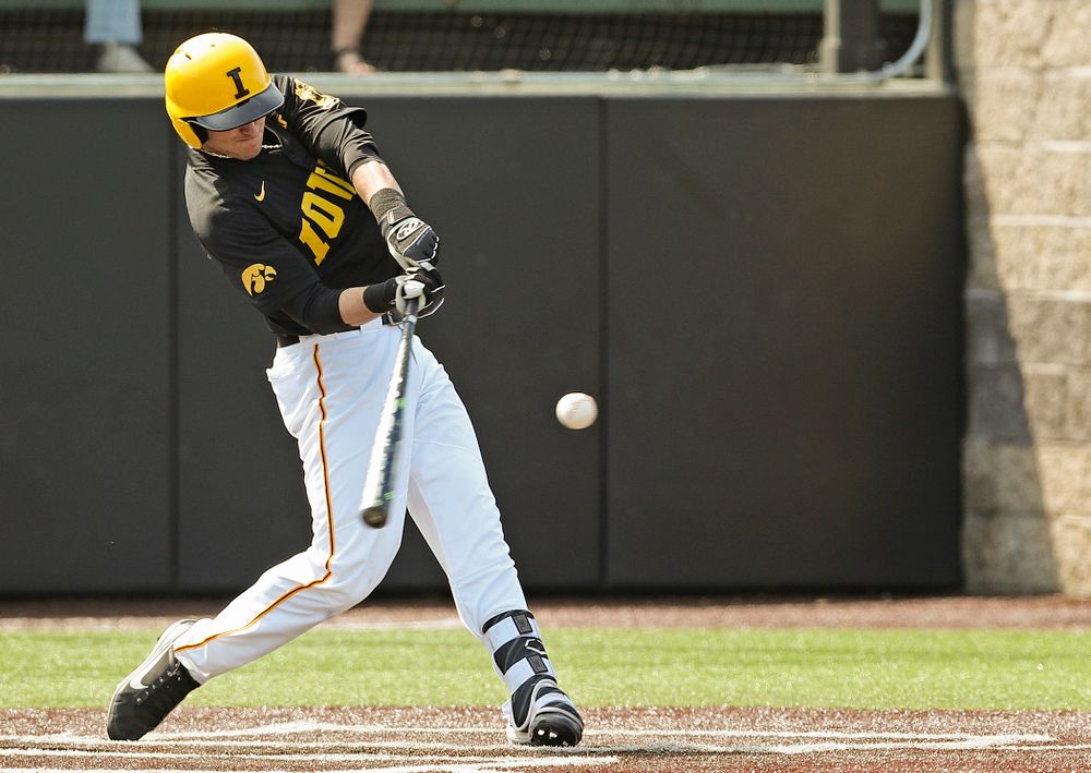 Iowa Hawkeyes shortstop Tanner Wetrich (16) hits a solo home run during the second inning of their game against Rutgers at Duane Banks Field in Iowa City on Saturday, Apr. 6, 2019. (Stephen Mally/hawkeyesports.com)