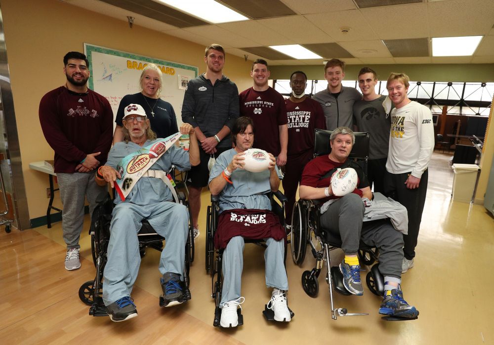 Iowa Hawkeyes quarterback Spencer Petras (7), punter Ryan Gersonde (2), and wide receiver Max Cooper (19) pose for photos with players from Mississippi State during a visit to Tampa General Hospital as part of the Outback Bowl Friday, December 28, 2018 in Tampa, FL.(Brian Ray/hawkeyesports.com) 