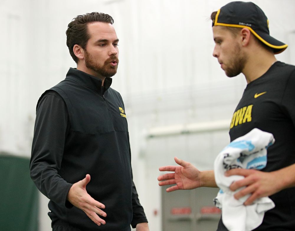 Iowa’s Mellecker Family head men’s tennis coach Ross Wilson (from left) talks with Will Davies serves during his match against Marquette at the Hawkeye Tennis and Recreation Complex in Iowa City on Saturday, January 25, 2020. (Stephen Mally/hawkeyesports.com)