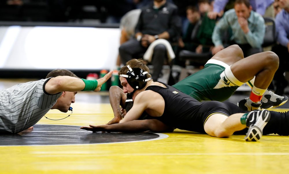 Iowa's Spencer Lee pins Michigan State's Rayvon Foley at 125 pounds. 