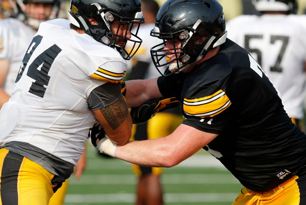 Iowa Hawkeyes defensive end A.J. Epenesa (94) and offensive lineman Mark Kallenberger (71) during camp practice No. 16 Tuesday, August 21, 2018 at the Hansen Football Performance Center. (Brian Ray/hawkeyesports.com)